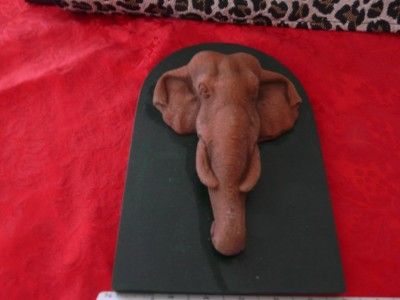 Really neat looking terracotta look elephant head mounted on a piece 